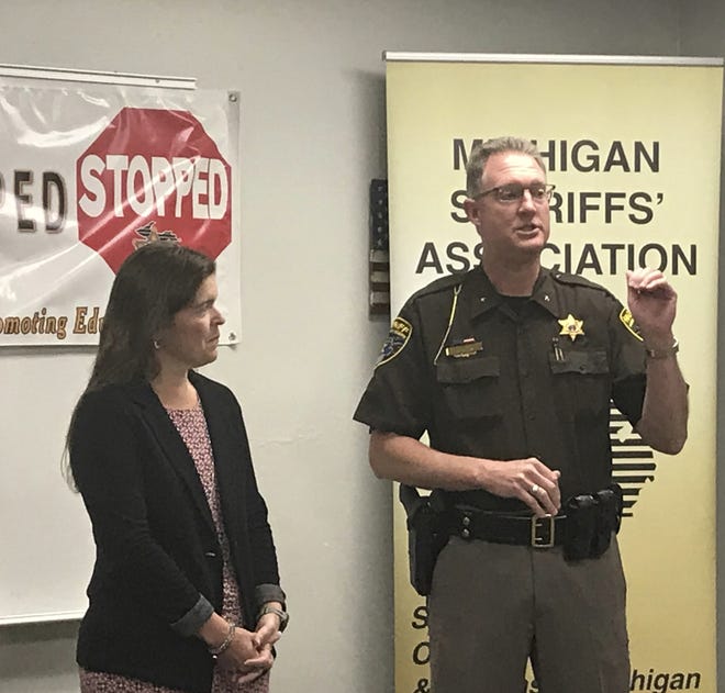 Livingston County Sheriff Michael Murphy, accompanied by Katie Pikkarainen, explains the STOPPED program at a kickoff event 

held Thursday, May 29, 2019 at the sheriff's office in Howell, Mich. (Kayla Daugherty/Livingston County Daily Press & Argus via AP)