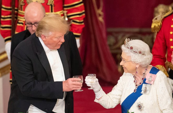 President Donald Trump and Queen Elizabeth II toast during the State Banquet at Buckingham Palace on Monday in London. Trump is on a three-day state visit to Britain. [Dominic Lipinski/The Associated Press]