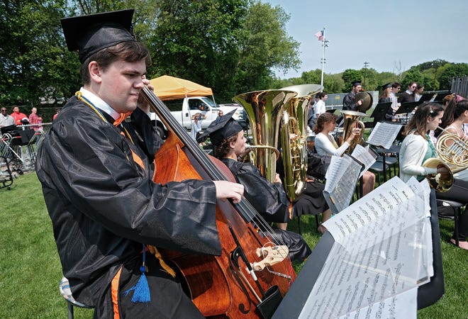 Class of 2019 graduate Sam Bigus plays the bass during the musical interlude by the Beverly High School Concert Band during the Beverly High School graduation ceremony on Sunday, June 2, at Hurd Stadium. Bigus was one of many Beverly High grads who received multiple scholarships. [Wicked Local Photo / Kirk R. Williamson]
