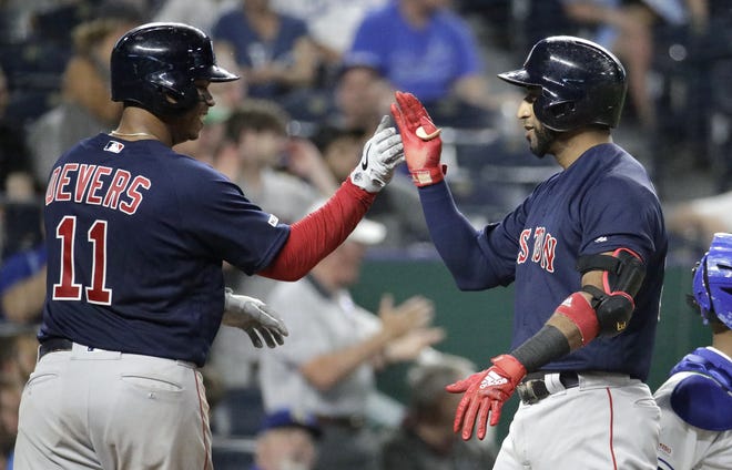 Boston Red Sox's Eduardo Nunez, right, celebrates with Rafael Devers (11) after hitting a three-run home run during the eighth inning of a baseball game against the Kansas City Royals on Tuesday in Kansas City. [Charlie Riedel/The Associated Press]
