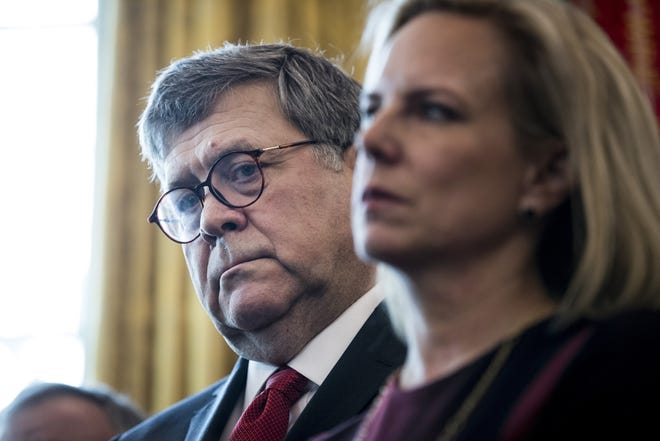 Attorney General William Barr, left, and Homeland Security Secretary Kirstjen Nielsen during a gathering in the Oval Office where President Donald Trump vetoed legislation that opposed his declaration of a national emergency to fund a wall along the southern border, at the White House in Washington, March 15, 2019. This was the first veto of Trump's presidency, and the bill had attracted significant Republican support in Congress. (Sarah Silbiger/The New York Times)