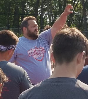 Northwest coach Joe Harbour makes a point to his players after finishing their conditioning program on Tuesday morning. (IndeOnline.com / Chris Easterling)