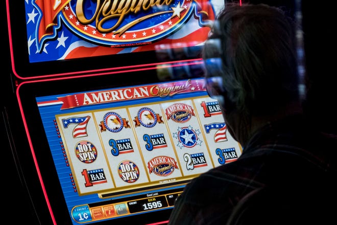 A man plays a video slot machine in a lounge at Huck’s, a truck stop in Mount Vernon. Under Illinois’ new gambling expansion, bars, restaurants, fraternal organizations and gambling parlors will be allowed to have six machines, up from five. Trucks stops will be permitted to hold 10 machines. (Whitney Curtis, special to ProPublica Illinois)
