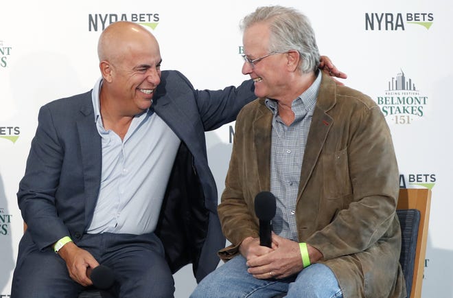 Mark Casse, left, War of Will's trainer, shares a laugh with Bill Mott, Tacitus' trainer, as they they joined Todd Pletcher and Dale Romans in a press conference Tuesday following a draw ceremony for the 2019 Belmont Stakes race in New York. [KATHY WILLENS/THE ASSOCIATED PRESS]