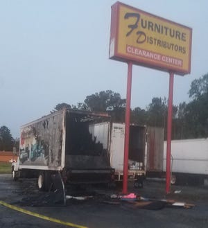 These truck trailers at Furniture Distributor in Havelock were set on fire early Tuesday morning by an unkonwn arsonist. [Contributed photo]