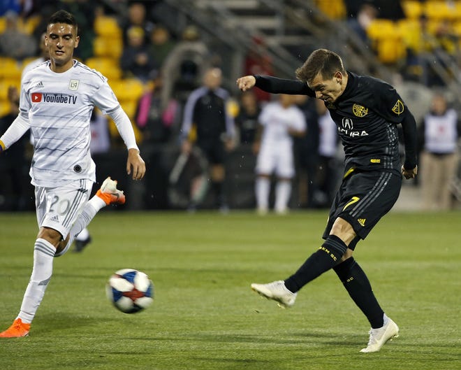 Pedro Santos takes a shot on goal past Los Angeles FC midfielder Eduard Atuesta during a game on May 11. Santos stepped Federico Higuain's playmaking role after Higuain suffered a season-ending knee injury. [Kyle Robertson/Dispatch]
