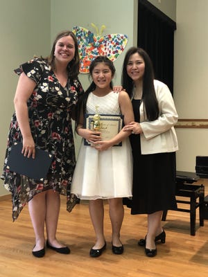Grace Ji was one of six HIngham students honored at a piano competition Tuesday, hosted by the South Shore Conservatory. To her left is Piano Department Chair Sarah Troxler, and to her right is her piano instructor HuMin Wang. (South Shore Conservatory)