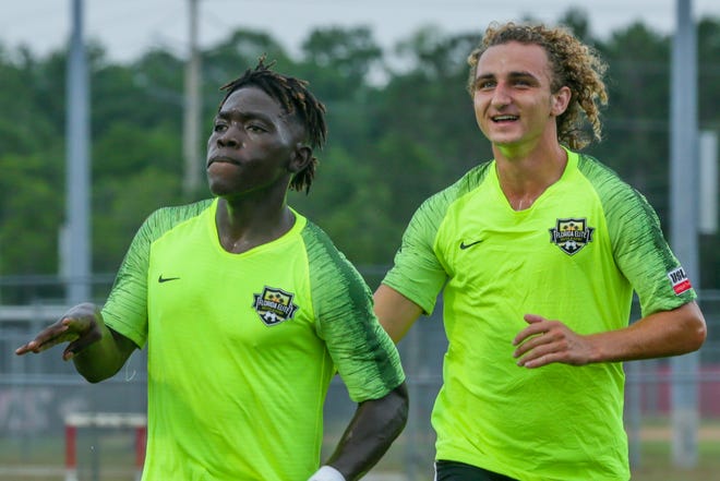 Marcel Joseph, left, celebrates with Trevin Myers after his opening goal of Florida Elite's USL League Two win over the Lakeland Tropics on Tuesday, June 4, 2019. Myers scored two goals and assisted a third in Florida Elite's 4-2 win. [WILL BROWN/ THE RECORD]