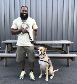 Army Veteran Corey Lee with his service dog, Roman. [CONTRIBUTED PHOTO]