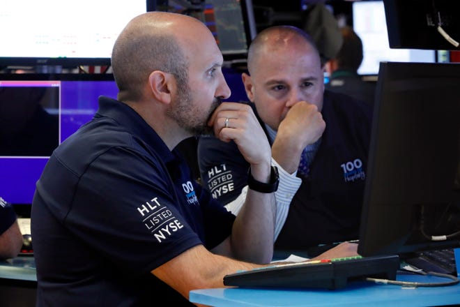 FILE - In this May 29, 2019, file photo specialists James Denaro, left, and Mario Picone work on the floor of the New York Stock Exchange. The U.S. stock market opens at 9:30 a.m. EDT on Wednesday, June 5. (AP Photo/Richard Drew, File)