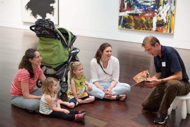 Blanton docent Gary Kattner, right, reads a book for (left to right) Mandy Kutz and daughter Effie, 3, Cate Bowman, 3, and mother Jillian Bontke Bowman during a storytime tour in the Blantan Museum of Art in 2014. This week kicks off all the summer programs at that museum. [American-Statesman 2014]