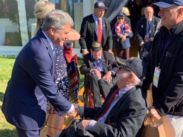 U.S. Rep. Michael McCaul, R-Austin, shakes the hand of a veteran Thursday at a D-Day commemoration in Normandy, France. [Contributed]