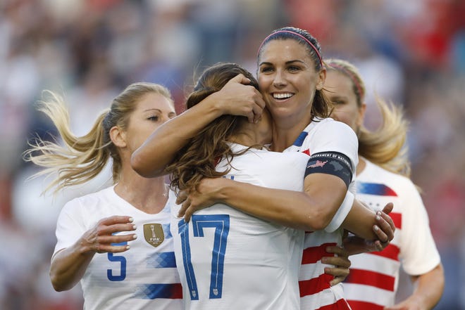 U.S. forward Alex Morgan, second from right, celebrates her hat trick with defender Tobin Heath (17) and other teammates during the second half of a Tournament of Nations soccer match against Japan on July 26, 2018, in Kansas City, Kan. [AP Photo/Colin E. Braley, File]
