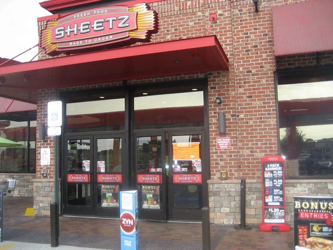 An orange notice on the door indicates a license is being sought for the sale of beer and wine at the Sheetz convenience store at 45 Antrim Commons Drive. SHAWN HARDY/ECHO PILOT