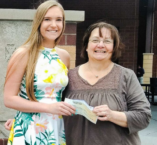 Knoxville High School graduate Alis Bickell presents a $1,185 check to Kathy Richardson for Safe Harbor Family Crisis Center. [SUBMITTED PHOTO]