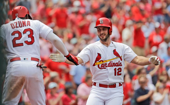St. Louis Cardinals' Paul DeJong (12) is congratulated by teammate Marcell Ozuna (23) after hitting a two-run home run against the Cincinnati Reds on Thursday in St. Louis. [AP Photo/Jeff Roberson]