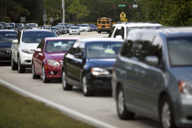 Traffic backs up along 117th Court North as children are released for a half day from Timber Trace Elementary School on October 10, 2013, in Palm Beach Gardens. The City has unveiled a Mobility Plan that will provide residents with safe, comfortable and convenient ways to move to and from homes, shops, schools and businesses. [FILE PHOTO/palmbeachpost.com]
