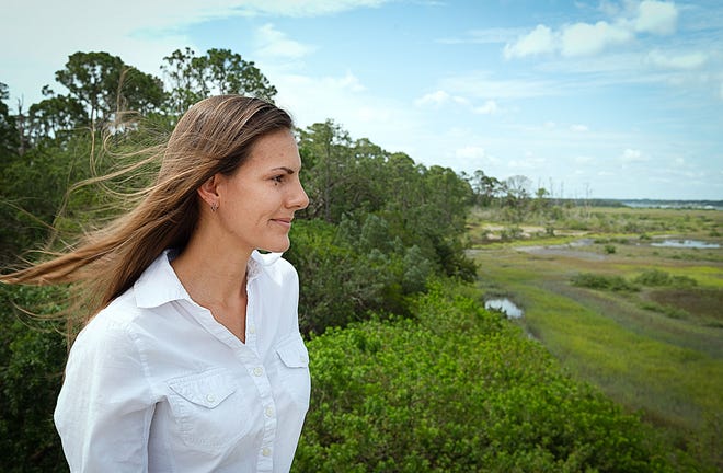 Matanzas Riverkeeper Jen Lomberk looks out over Fish Island in St. Augustine from the State Road 312 bridge on Thursday. Lomberk has been active in efforts to preserve the land on Fish Island from being developed. [PETER WILLOTT/THE RECORD]
