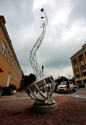 Shelby's new sculpture decorates the sidewalk on South Washington Street in uptown Shelby on Wednesday. [Brittany Randolph/The Star]