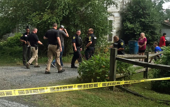 Cleveland County Sheriff's deputies head into a home on Jim Elliott Road after a shooting took place outside the house Thursday afternoon. [Joyce Orlando/The Star]