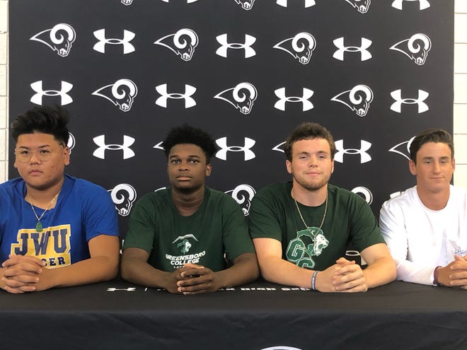 Havelock High School student athletes (left to right) Vincent Diep (Johnson and Wales for soccer), Isaiah Cooper (Greensboro College for lacrosse), Ryan Buchanan (Greensboro College for football) and Tanner Murray (Lenoir Community College for baseball) sign their National Letters of Intent Wednesday at the high school. [CONTRIBUTED PHOTO]