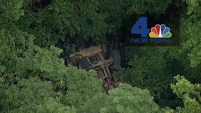 In this photo taken from video provided by NBC New York, a light medium tactical vehicle sits overturned near the Camp Natural Bridge summer military training camp off Route 293, Thursday, June 6, 2019 in Cornwall, N.Y. West Point officials say one cadet was killed and over a dozen people were injured when the vehicle they were riding in for summer training overturned. (NBC New York via AP)