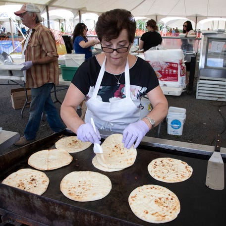 Lori Panagiotopoulos grills up pita bread.