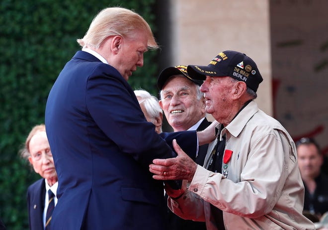 U.S. President Donald Trump greets a U.S War veteran during a ceremony to mark the 75th anniversary of D-Day at the Normandy American Cemetery in Colleville-sur-Mer, Normandy, France, Thursday, June 6, 2019. World leaders are gathered Thursday in France to mark the 75th anniversary of the D-Day landings. (Ian Langsdon/POOL via AP)