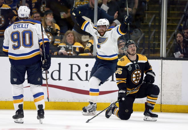 St. Louis Blues' David Perron (center) celebrates his goal behind Boston Bruins' Noel Acciari (right) during the third period of the Blues 2-1 win in Game 5 of the Stanley Cup Final on Thursday. (AP Photo/Michael Dwyer)