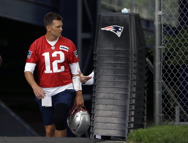 New England Patriots quarterback Tom Brady steps on the field before the start of Thursday's minicamp practice in Foxboro. (AP Photo/Steven Senne)