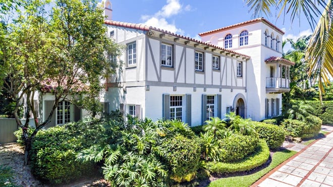 This landmarked house at 240 Jungle Road in Palm Beach just changed hands for $750,000 less than the $8.2 million it sold for in November 2018., according to the prices made public with the deeds. [Photo by Giles Bradford, courtesy Brown Harris Stevens]