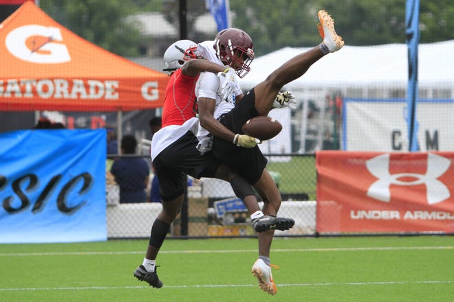 A Jenkins defender, left, tries to break up a pass for a New Hampstead receiver during the Cam Newton Foundation 7v7 Football Tournament on Friday at the Jennifer Ross Soccer Complex. [PHILIP HALL/SAVANNAHNOW.COM]