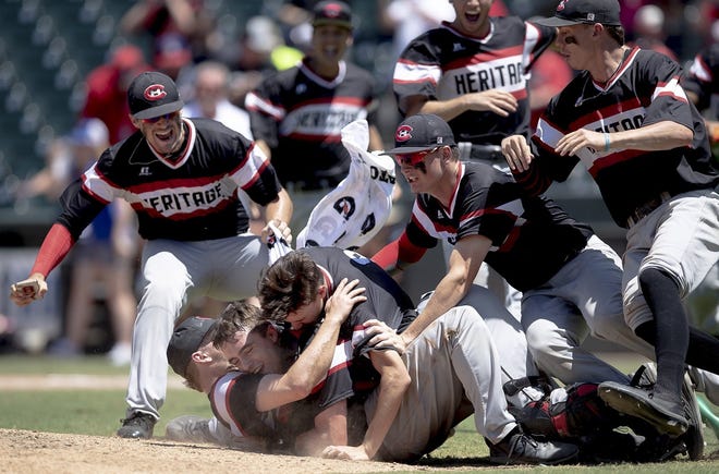 Colleyville Heritage players pile on top of pitcher Chandler Freeman after defeating Georgetown to win the Class 5A state baseball championship Saturday. [NICK WAGNER/AMERICAN-STATESMAN]