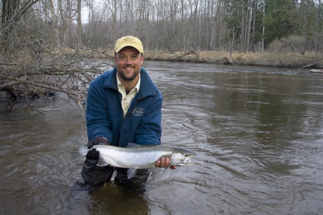 Kevin Morlock of Indigo Guide Service poses with a Pere Marquette steelhead. [Submitted]