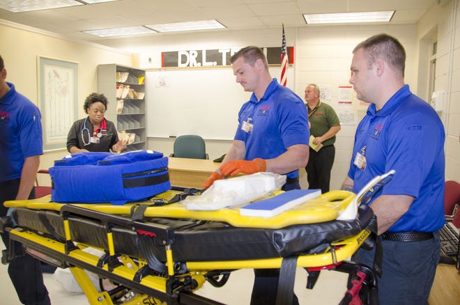 Lake Tech paramedic students enter the scene of a practice drill, where an instructor guides them through the process. [Lake Technical College]