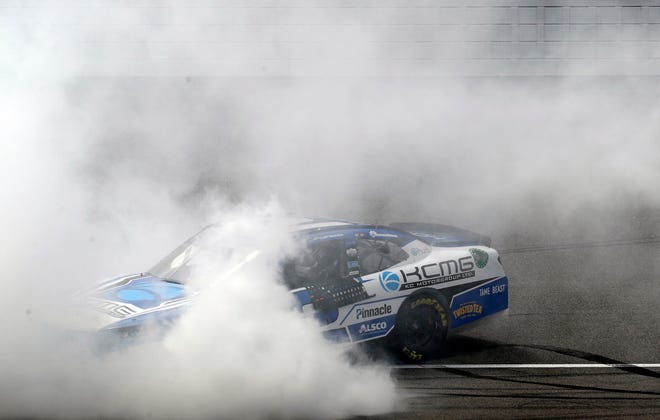 Tyler Reddick celebrates with a burnout after winning the NASCAR Xfinity Series auto race at Michigan International Speedway, Saturday, June 8, 2019, in Brooklyn, Mich. (AP Photo/Carlos Osorio)