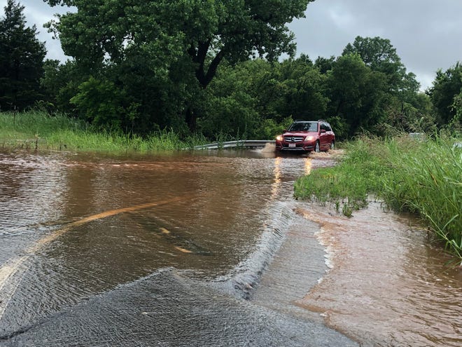 Drivers go through high water on NW 150 just east of N MacArthur in Oklahoma City Sunday, June 9, 2019. [Robert Medley/The Oklahoman]