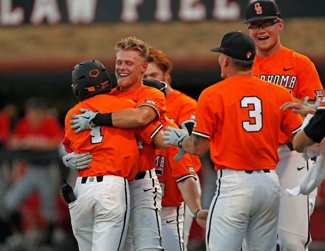 Oklahoma State players celebrate after Noah Sifrit (14) scored the game-winning run during the ninth inning in Game 2 of the team's NCAA college baseball tournament super regional against Texas Tech, Saturday, June 8, 2019, in Lubbock, Texas. (AP Photo/Brad Tollefson)