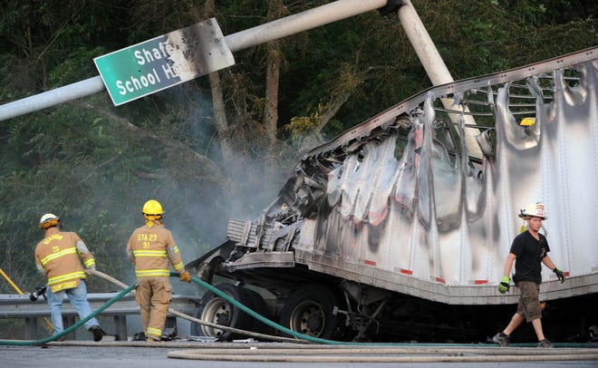 Firefighters at the scene of a 6-vehicle accident at the intersection of Shafers Schoolhouse Road and Route 209 in Stroud Township on June 24, 2010. [POCONO RECORD ARCHIVE]