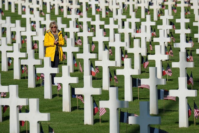 A visitor walks among graves at the Normandy American Cemetery on the 75th anniversary of the World War II Allied D-Day invasion on June 06, near Colleville-Sur-Mer, France. [Sean Gallup / Getty Images / TNS]