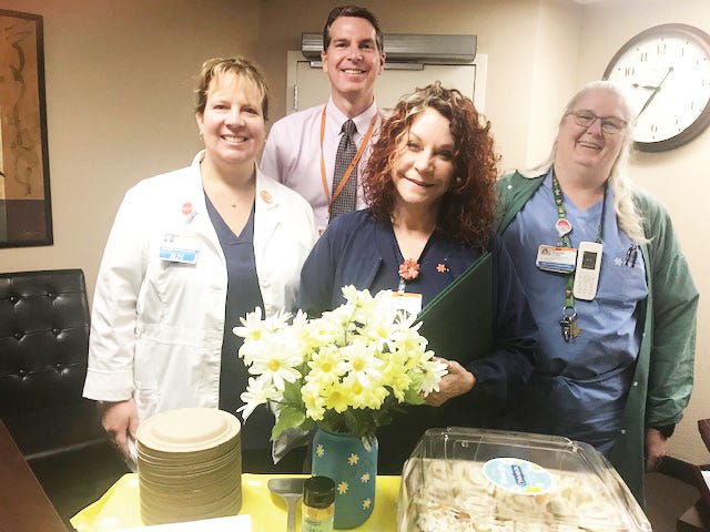 Mercy Mt. Shasta’s Clinical Supervisor Canada Ross, Hospital President Rodger Page, and 
Director of Nursing celebrate Registered Nurse Linda Moreno, center, as she received the DAISY Award last week.