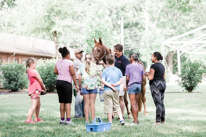 Rising fifth-graders participating in summer camp at The Banker's House in uptown Shelby learn about local history, the property and horses. [Special to The Star]