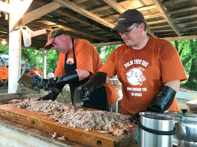 Gary Lee (left) and Doug Satterfield chop pork for a fundraising meal on May 4 at a shed behind Palm Tree United Methodist Church in Lawndale. [Wade Allen/The Shelby Star]