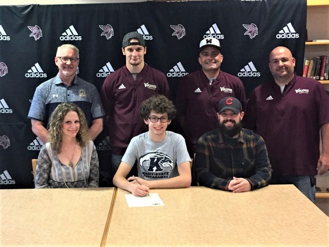 Signing a letter of intent to attend and wrestle at Kent State Tuscarawas is Waterloo's Tyler Ernst who is seated between his mother, Erin Eby and father, Craig Porter. Looking on from the back row are Dave Schlarb, KSU Tusc Head Wrestling Coach, Nate Fry Waterloo Assistant Wrestling Coach, Brian Munger Waterloo Head Wrestling Coach, and John Foster Waterloo Assistant Wrestling Coach. Ernst, a 132-pounder, was a three-year letter winner for the Vikings and served as the captain for both the wrestling and football teams his senior year. During his senior season on the mats, Ernst compiled 31 wins, capturing his second championship at the Crestview Cougar Classic. He placed 4th at the Jackson Milton Invitational and capped off his wrestling career as an alternate to the state meet. Submitted photo