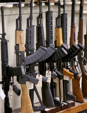 A portion of the rack displaying various models of semi-automatic sporting rifles is seen at Duke's Sport Shop in New Castle, Pa. [AP Photo/Keith Srakocic]