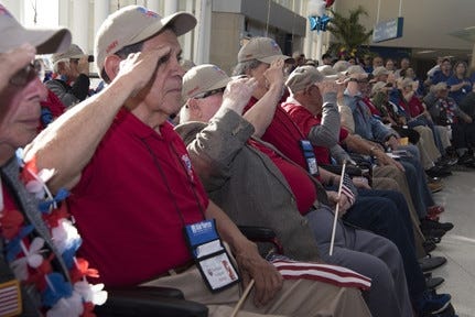 Veterans in the Honor Flight San Antonio salute while the United States National Anthem plays at a welcome home celebration and ceremony at one of the many Honor Flight Hubs across the country. [U.S. AIR FORCE/ AIRMAN SHELBY PRUITT PHOTO]