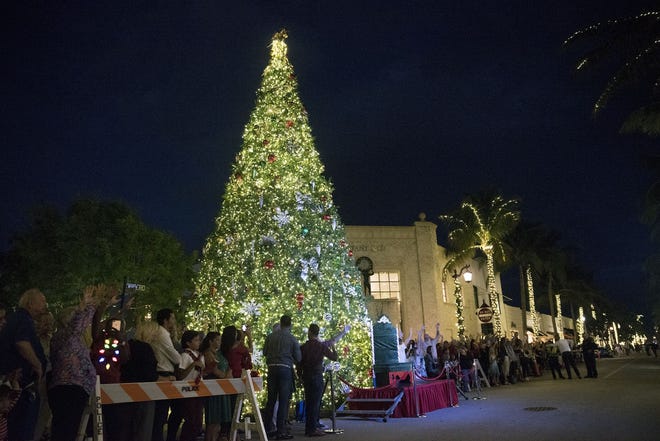 Hundreds gather around the 40-foot-tall Christmas tree while waiting for the arrival of Santa Claus during the Worth Avenue parade in Palm Beach on Nov. 28, 2017. [Andres Leiva/palmbeachdailynews.com file photo]