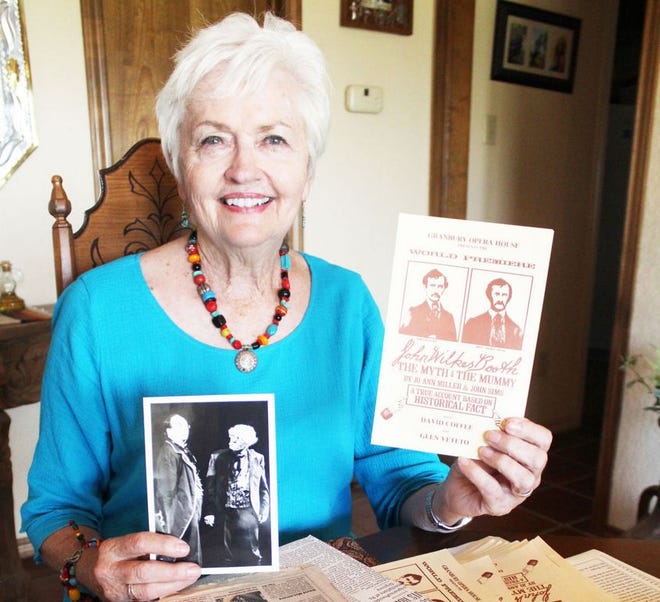 Cathey Hartmann, chairman of the Erath County Historical Commission, shows some of the photos and articles she has saved in connection with a play co-written by her first husband, the late John Sims, titled "John Wilkes Booth: The Myth and the Mummy."