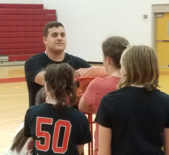 New Northwest girls basketball coach Kevin Lower talks to a group of junior high players during a workout on Wednesday morning. (IndeOnline.com / Chris Easterling)