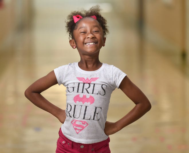 Taige Marie Leathers, 7, a second-grader at R.L. Brown Elementary, poses in a school hallway on Thursday. She waited hours to speak at the public hearing portion of Tuesday's City Council meeting. [Will Dickey/Florida Times-Union]